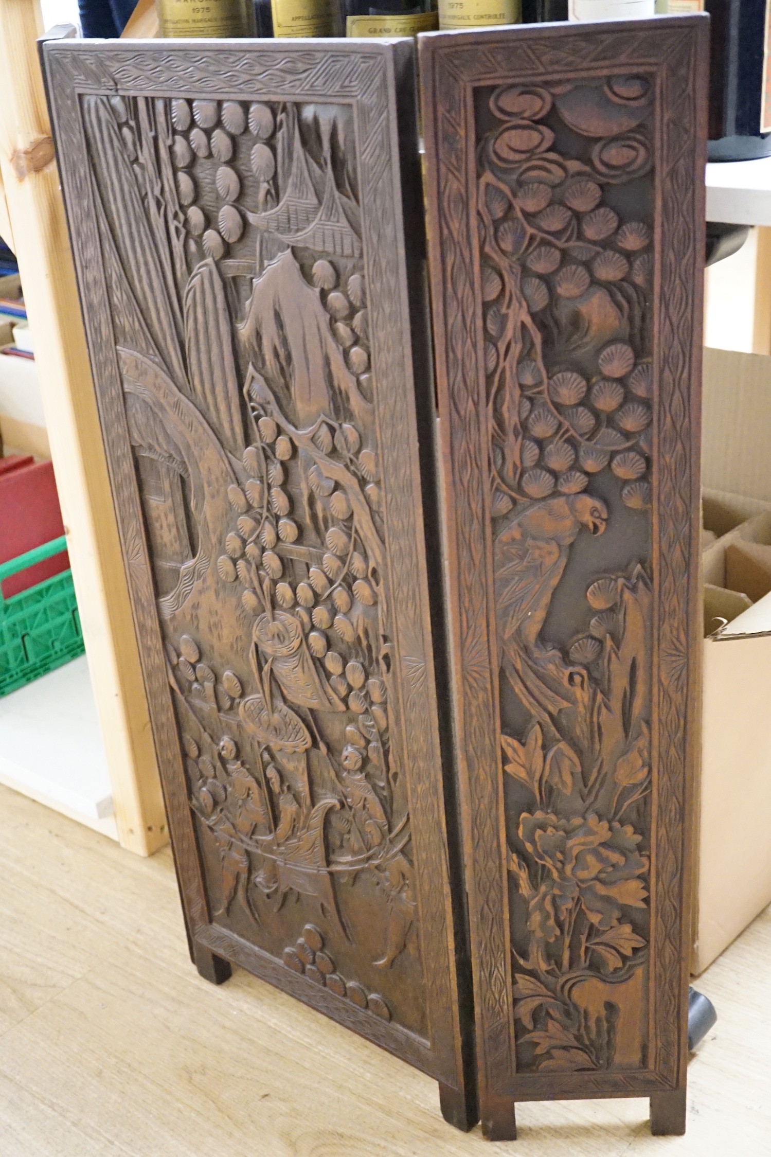 An Oriental three panelled carved wood folding screen, 84cm tall